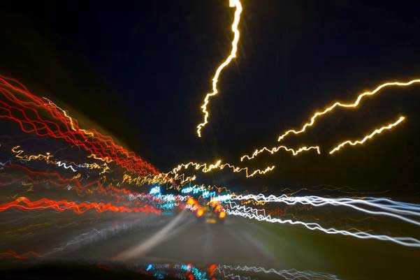 Blurred nighttime road from perspective of a drugged driver